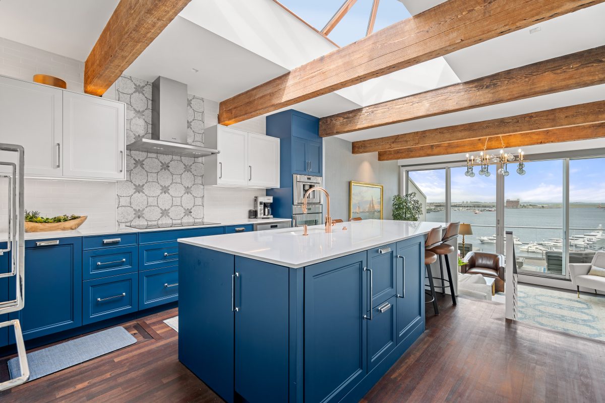 Photography of a boston kitchen with blue cabinets and skylights