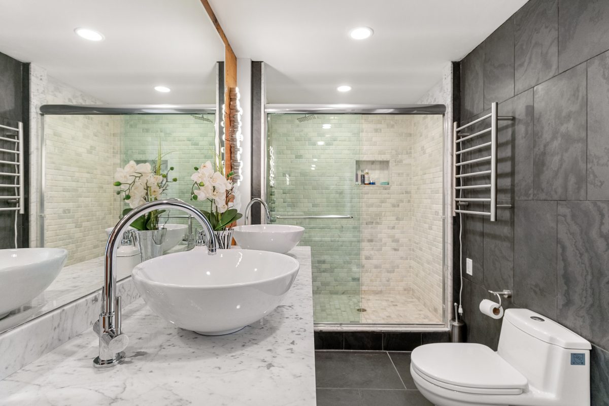 Real Estate photo of a bathroom with bowl sink and standup shower