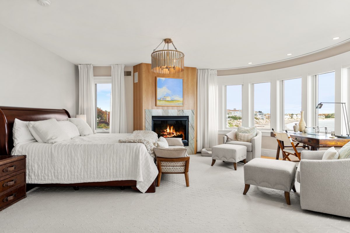 Photo of main bedroom suite with fireplace and ocean views in vacation rental