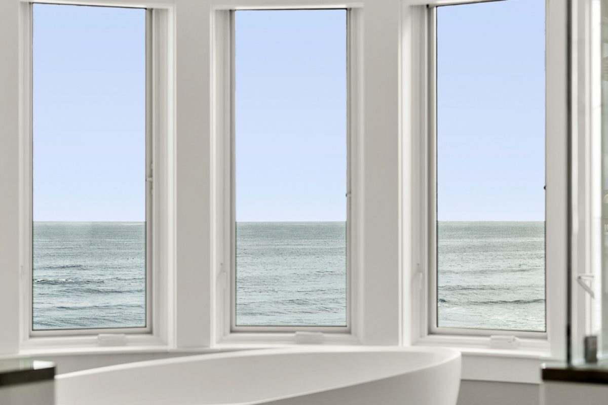 Punched in photograph of bathtub in a vacation rental with ocean view