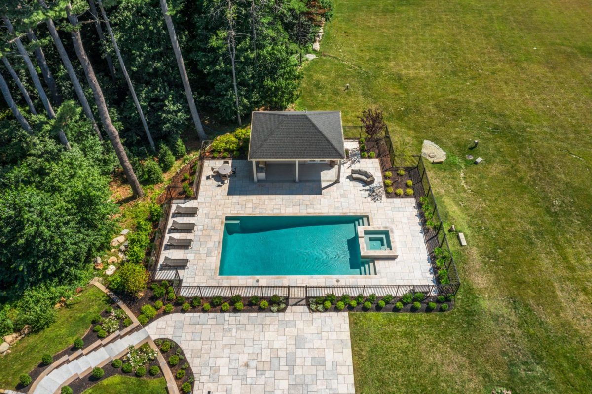 Real estate photography of backyard pool in milton with grass