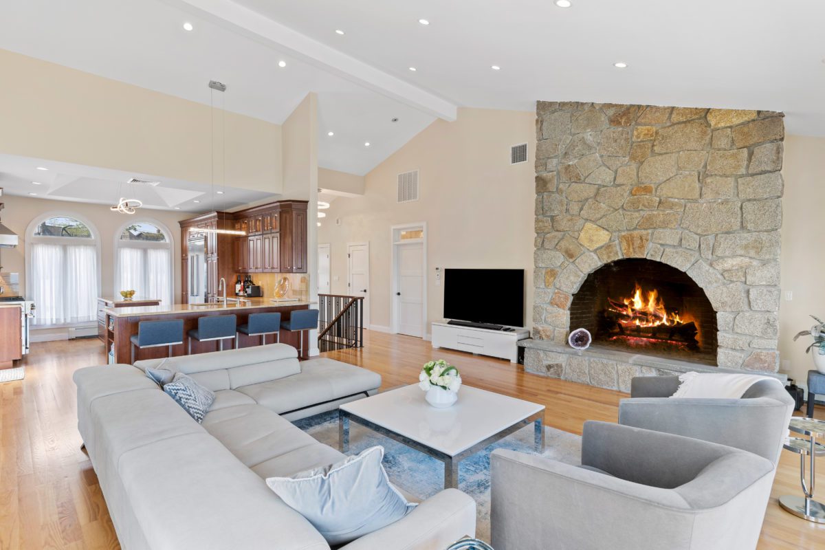 Living area with lit fireplace in Nahant